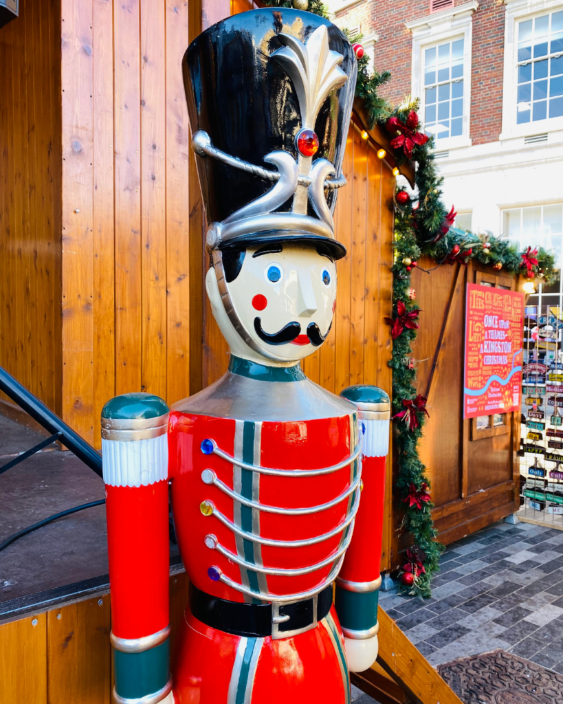 A life sized toy soldier standing by the front of the stage