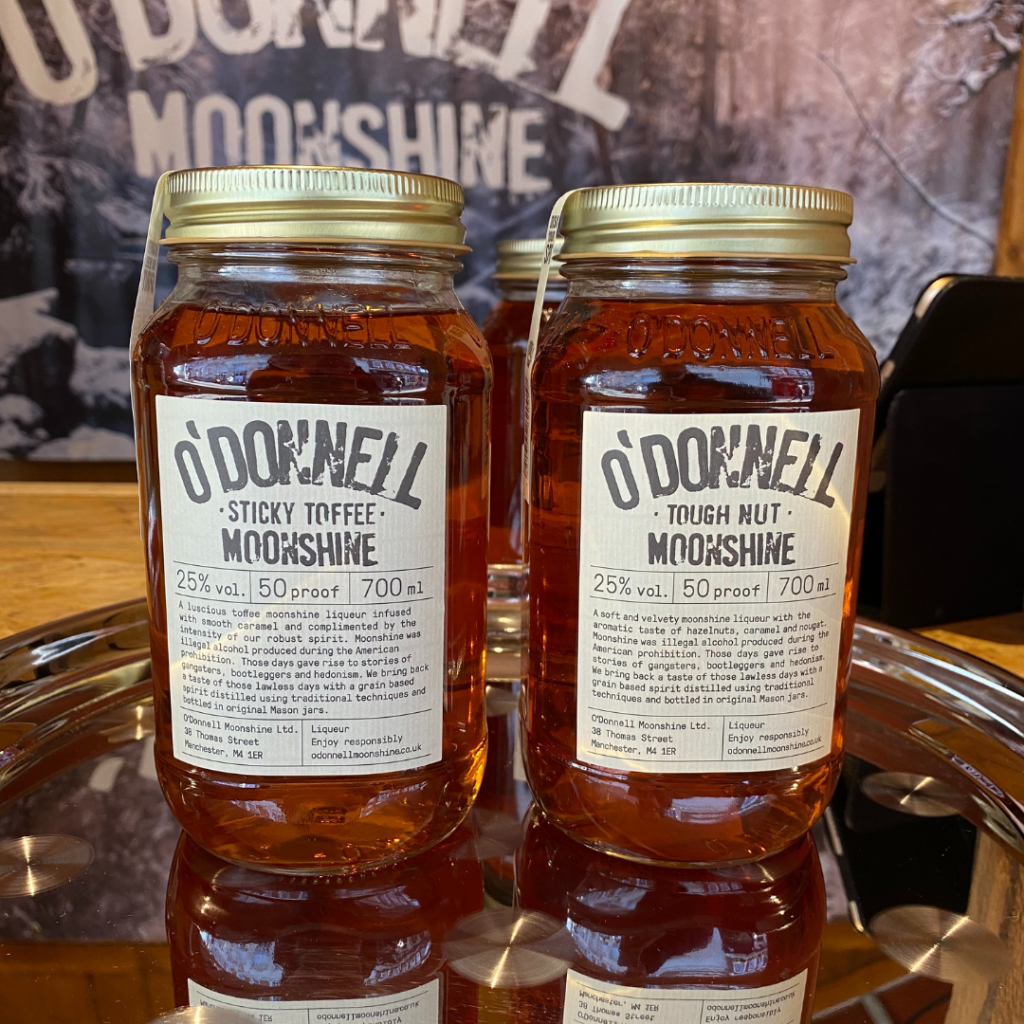 Kingston Christmas Market traders O'Donnell Moonshine displaying two jars of Moonshine on a silver tray